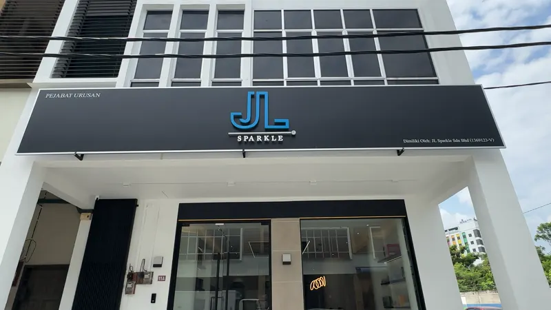 The JL Sparkle shopfront on Jalan Syarikat 1 — a dark signboard carrying the blue JL SPARKLE mark above full-height glass doors.